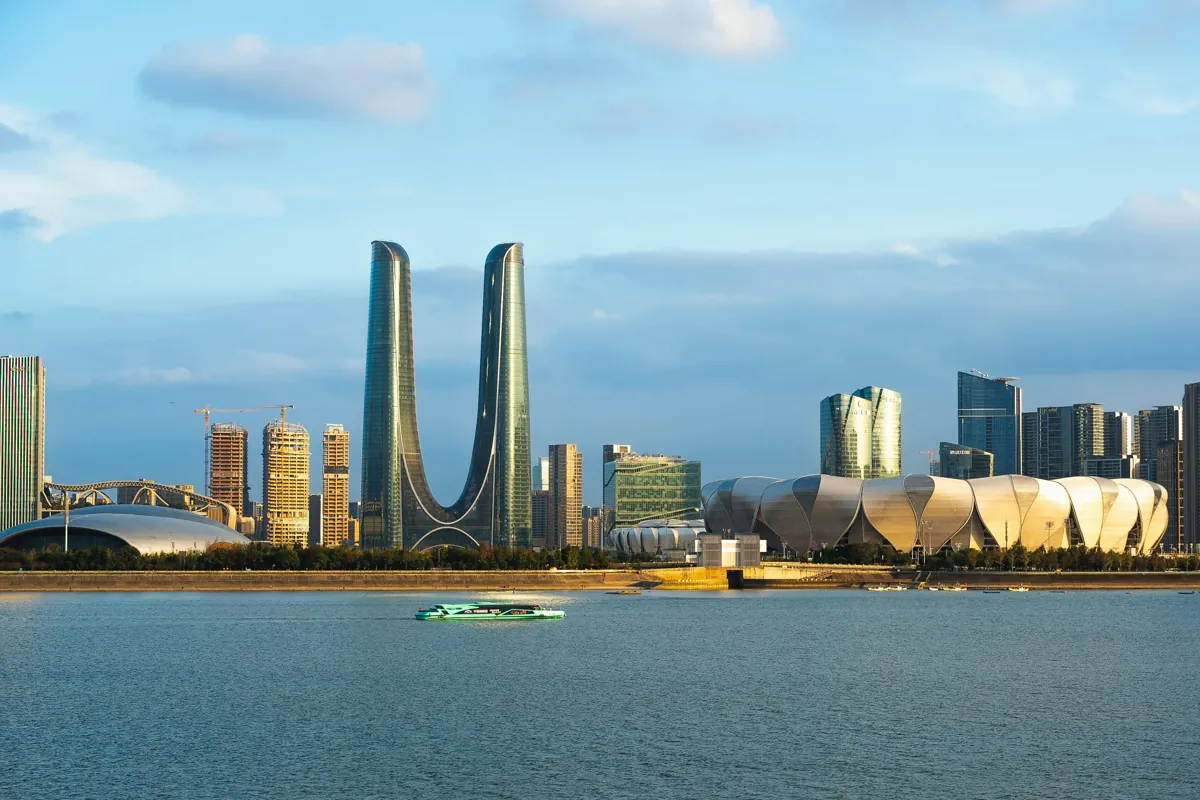 Modern skyline by the Qiantang River in Hangzhou, including the Olympic Sports Center.