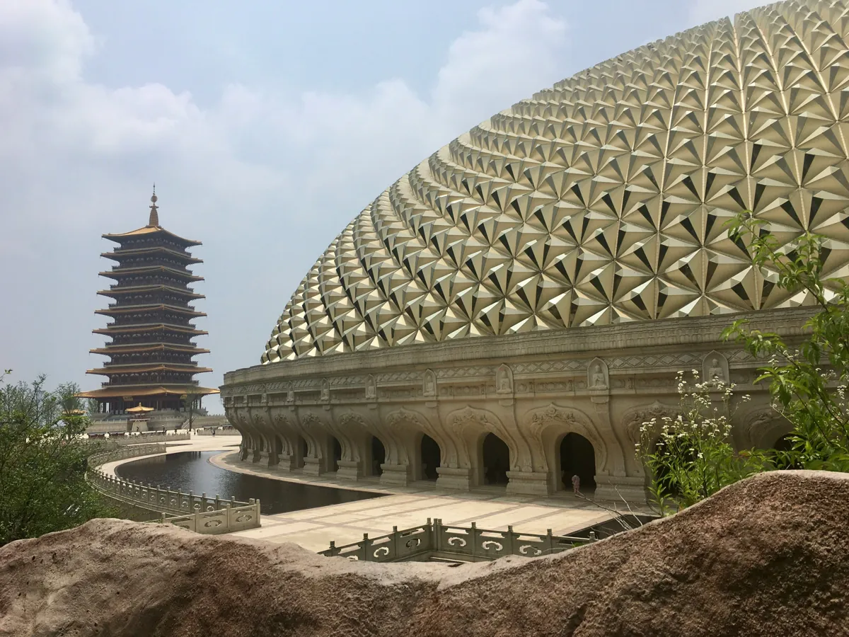 Niushoushan (牛首山) in Nanjing, with the golden Usnisa Palace and its pagoda reflected beside the curved waterway.