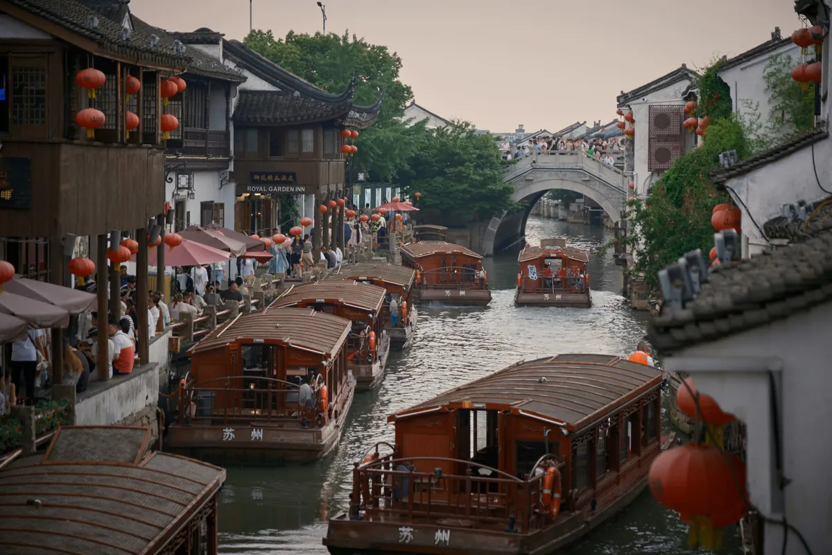 The historic Shantang Street (山塘街) canal in Suzhou, lined with lanterns and old waterfront houses.