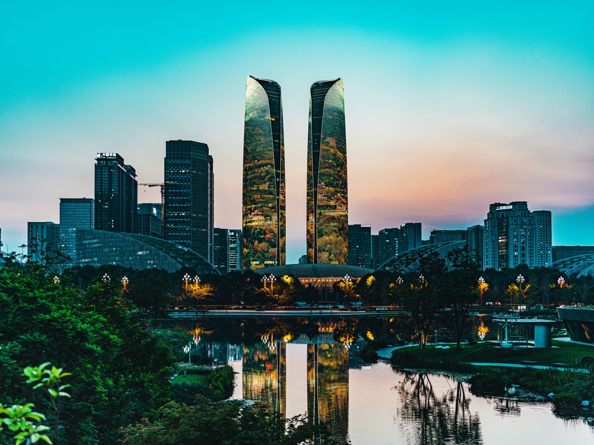 The Tianfu Twin Towers reflected over Financial City Park in Chengdu.